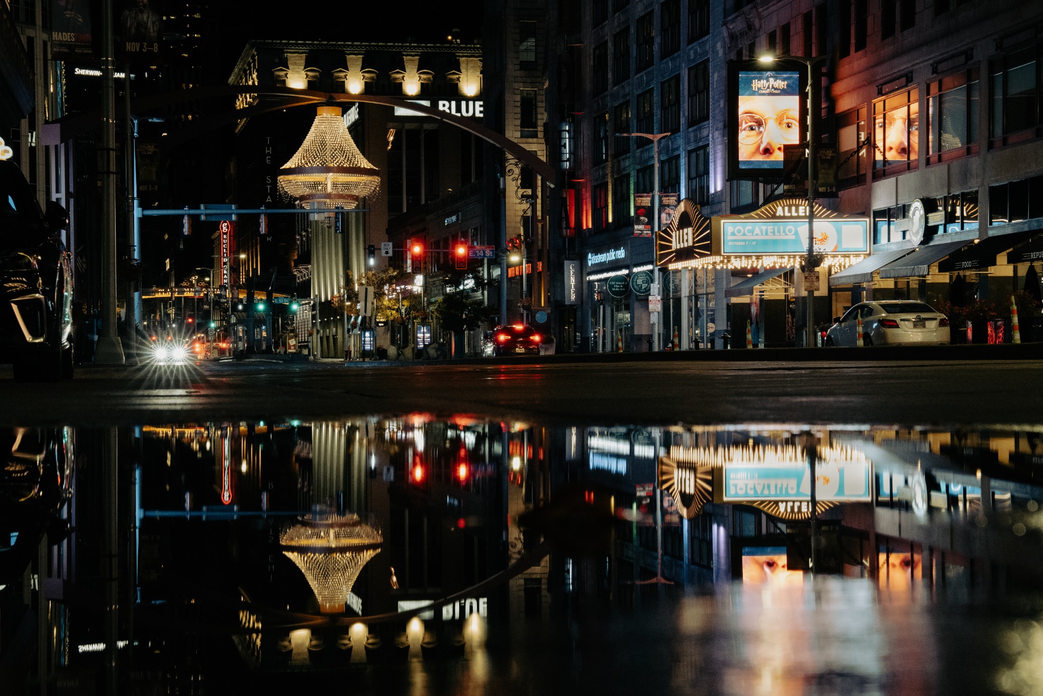 Night city street reflected in a puddle